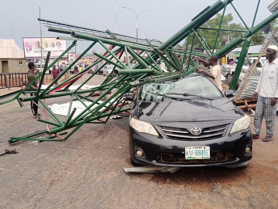 2 Miraculously  Escape Unhurt  As Billboard Poles Fall Onto Car In Ilorin